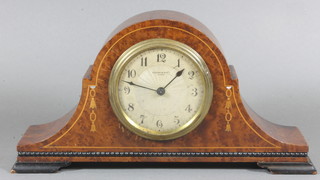 An Art Deco bedroom timepiece with silvered dial and Arabic numerals contained in an inlaid burr walnut arch shaped case  11.5"
