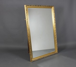 A rectangular bevelled plate wall mirror contained in a decorative  frame 53"h x 35"w