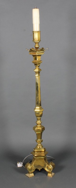 An ecclesiastical style octagonal brass candlestick converted to a  standard lamp