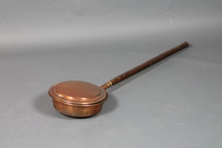 A 19th Century copper warming pan with turned elm handle