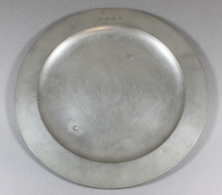 A circular pewter charger with London touch mark, decorated the  Arms of St Bartholomew's hospital 11"