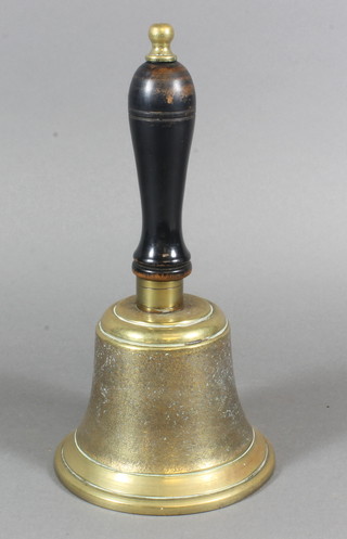 A brass hand bell with turned ebony handle
