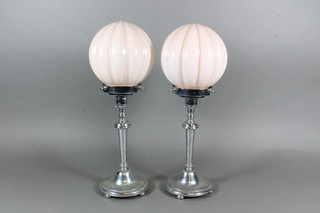 A pair of 1930's Art Deco chromium plated table lamps with  pink glass shades 16"