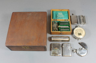 A wooden box with hinged lid containing a volt meter, a Star  razor, a cigarette rolling machine, 2 lighters etc