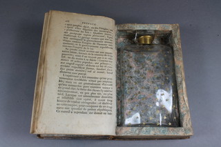 An 18th Century leather bound book containing a Victorian glass  flask 5"