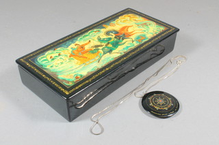 A Russian lacquered trinket box with hinged lid 9" together with  a circular lacquered pendant 2"