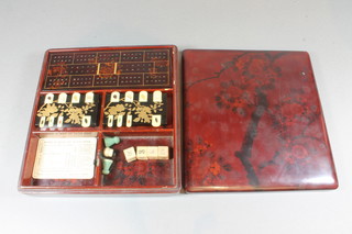 A Chinese rectangular lacquered card box containing a rectangular cribbage board and 2 Bezique markers 9"