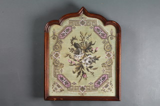 A Victorian bead work panel contained in a mahogany shield  shaped frame 19" x 16"