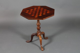 A Victorian octagonal mahogany games table inlaid a chess  board, raised on fluted columns and tripod base 20"w