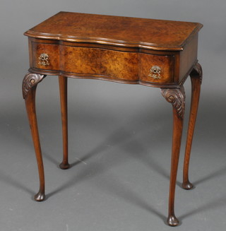 A Queen Anne style figured walnut side table of serpentine outline, raised on cabriole legs 25"h x 23.5"w x 13"d