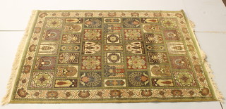A machine made green ground Persian style rug with geometric  design 59" x 56"