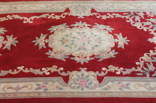 A red ground and floral patterned Chinese runner with floral  decoration 122" x 72"