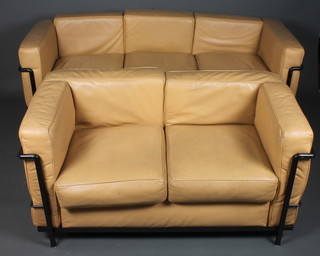 In the style of Corbusier a metal framed 2 seat settee upholstered  in brown hide together with a matching 3 seat settee