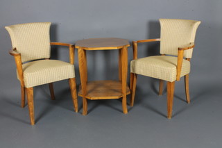 In the style of Gordon Russell, a pair of beech open arm chairs together with an octagonal occasional table