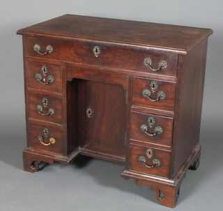 A George III mahogany kneehole pedestal dressing table fitted 1 long drawer above a secret drawer, the pedestal fitted a cupboard  and 6 short drawers, raised on bracket feet 31"h x 35"w x 20.5"   ILLUSTRATED
