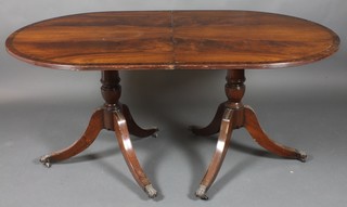 A Georgian style mahogany D end extending dining table with 2 extra leaves, raised on pillar and tripod supports 29"h x 102"l