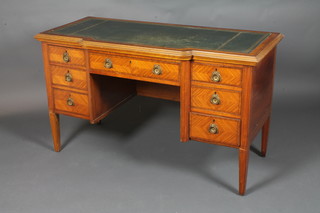 An Edwardian Kingwood writing table with inset green skiver,  and crossbanded top, fitted 1 long and 6 short drawers raised on  square tapering supports 30"h x 50"w x 22"d