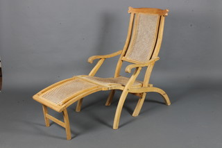 A bleached mahogany steamer chair with woven cane seat, back  and foot rest