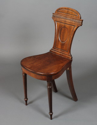 A late Victorian mahogany side chair in the Sheraton taste, having a shaped relief carved back, solid seat, raised on ring  turned tapered legs
