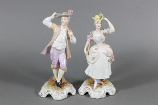 A pair of German porcelain figures of standing lady and gentleman, impressed 57 Germany, lady f and r, 7"