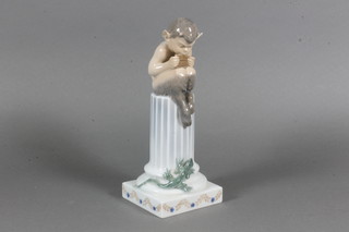 A Royal Copenhagen porcelain figure of a seated Pan on reeded column, the base marked 433 8"