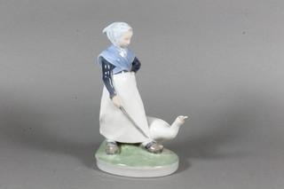 A Royal Copenhagen porcelain figure of a standing lady driving a goose, base marked 528 7"