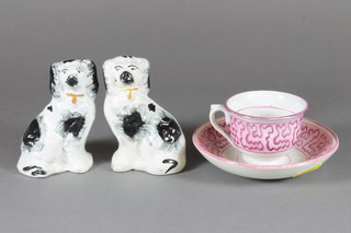 A pair of Staffordshire black and white figures of seated dogs 4"  and a pink lustre tea cup and saucer