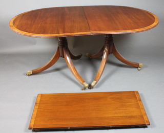 A late George III style mahogany D end extending dining table, crossbanded, raised on ring turned column supports, tripod bases  with brass caps and casters 29"h x 42"w x 85"l
