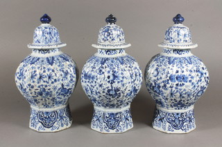 3 19th Century Delft blue and white octagonal urns and covers  9.5"