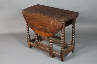 An 18th Century oak gateleg table raised on a turned under frame with peg feet 26"h x 31"d