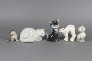 A white glazed Beswick figure of a seated cat 2.5", an oval  figure of a cat 2", a Soviet Russian porcelain figure of a seated  cat 3" and a Spanish figure of a cat