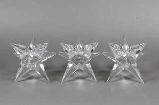 A Swarovski star shaped candlestick 4" and 2 other star shaped candlesticks 3.5"