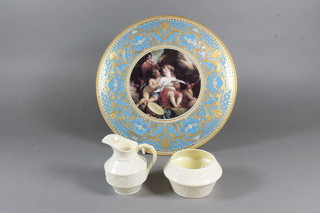A Beleek cream jug and sugar bowl with green mark to base 3"  and a circular turquoise and gilt banded porcelain plaque  decorated a cherub, the reverse marked M Hunter 11"