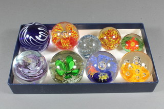 A collection of 9 glass paperweights