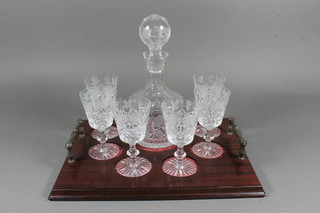An Edinburgh crystal liqueur set comprising 9" club shaped  decanter and stopper, 6 liqueur glasses complete with a mahogany twin handled tray