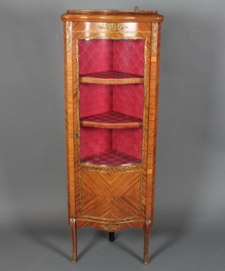 A 20th Century Kingwood and gilt mounted corner cabinet of serpentine outline, fitted shelves enclosed by a panelled mirrored door, raised on cabriole supports 59"h x 22"w x 39"d