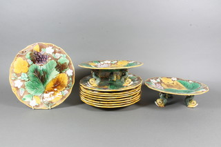 An 11 piece Victorian Wedgwood Majolica fruit service  comprising 2 circular comports 9" raised on dolphin supports,  marked Wedgwood and impressed Wedgwood BUX F and 9  circular plates 9" - 2 with chips to rim impressed Wedgwood TP