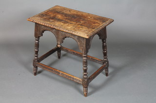 An 18th Century style carved oak low side table, having chip carved rectangular top above shaped aprons, raised on turned  supports united by stretchers 23"h x 24"w x 16"d