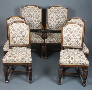 A set of 6 late Victorian oak dining chairs in the early 18th Century style, 2 having arms, with tapestry woven upholstery,  raised on acanthus leaf carved supports, bun feet