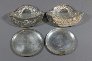 A pair of embossed Eastern silver dish handles and 2 circular engraved silver pin trays, 4 ozs