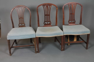 A set of 3 late 18th Century Hepplewhite style mahogany dining chairs with pierced and shaped splats, stuff over seats on square  tapered legs