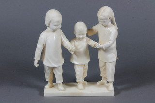 A Japanese carved ivory figure group of 3 standing children, signed, 5"