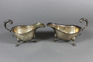 2 similar silver sauce boats with C scroll handles, raised on hoof feet, Birmingham 1937, 5 ozs
