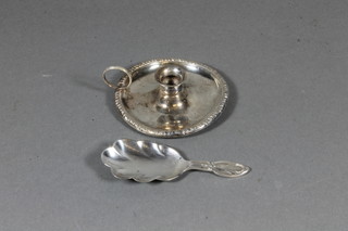 An Edwardian miniature silver chamber stick Chester 1901 and a silver caddy spoon Birmingham 1930