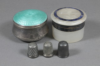 An Art Deco circular silver dressing table jar with green enamelled lid, Birmingham 1936 2.5", a white marble jar and  cover with silver mounts 2", 2 silver thimbles and 1 other