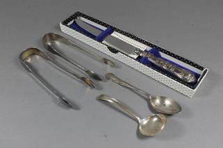 A pair of George III silver sugar tongs London 1801, a silver teaspoon, a small silver ladle 2 ozs, a silver handled cake knife  etc