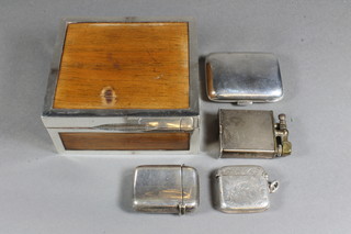 A wooden and silver mounted cigarette box, a silver vesta case, a silver match slip, plated vesta case and lighter