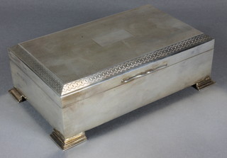 An Art Deco rectangular silver cigarette box with engine turned decoration raised on bracket feet Birmingham 1921 7"   ILLUSTRATED