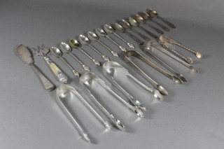 6 pairs of silver sugar tongs, 7 silver apostle spoons, 6 silver  coffee spoons, a silver butter knife 11 ozs and a silver bladed  fork