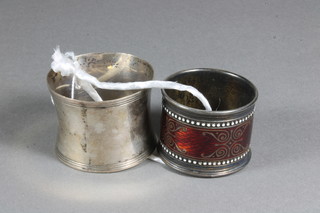 An enamelled napkin ring and 1 other